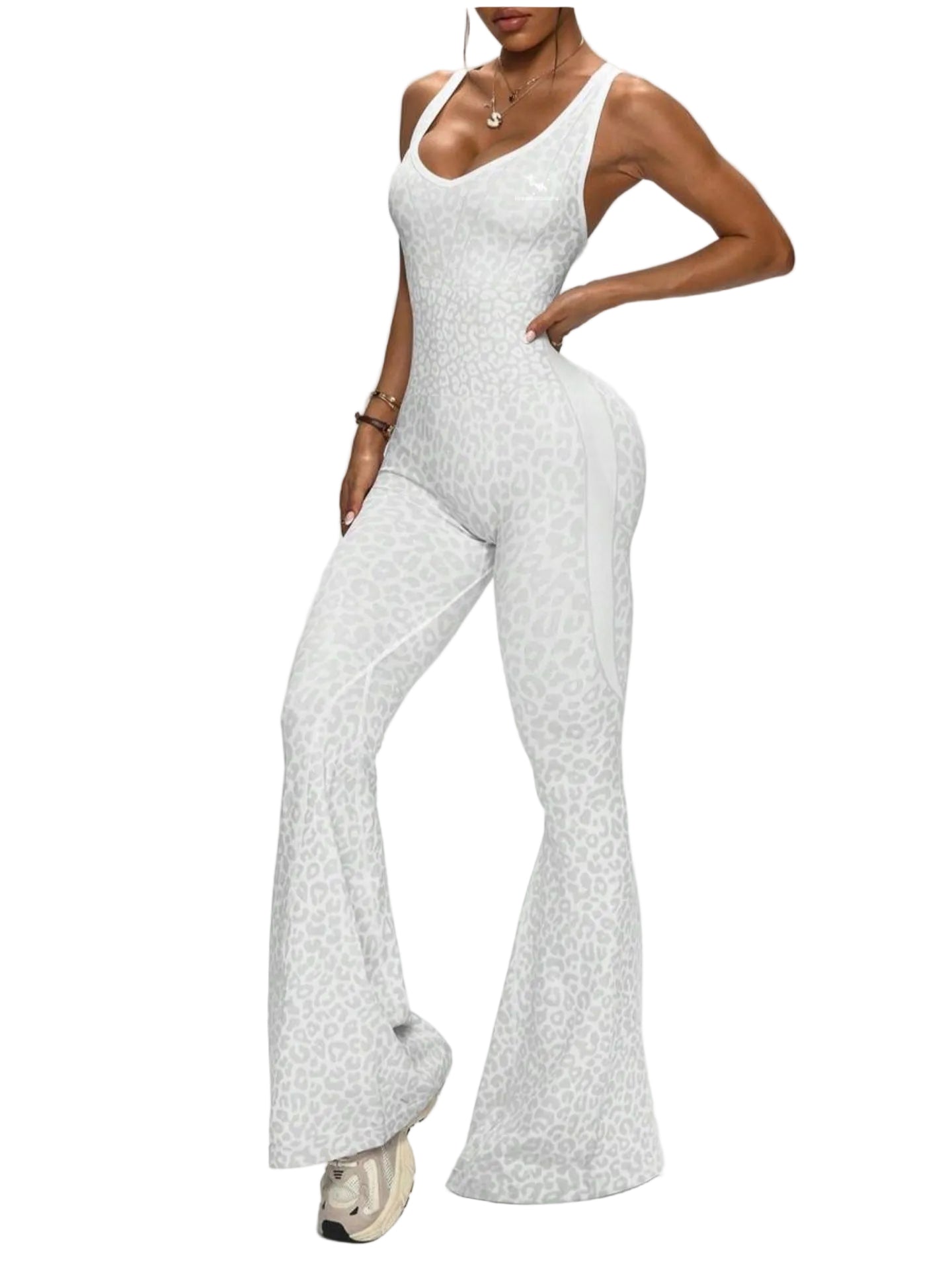 Person wearing a white patterned jumpsuit on a plain background
