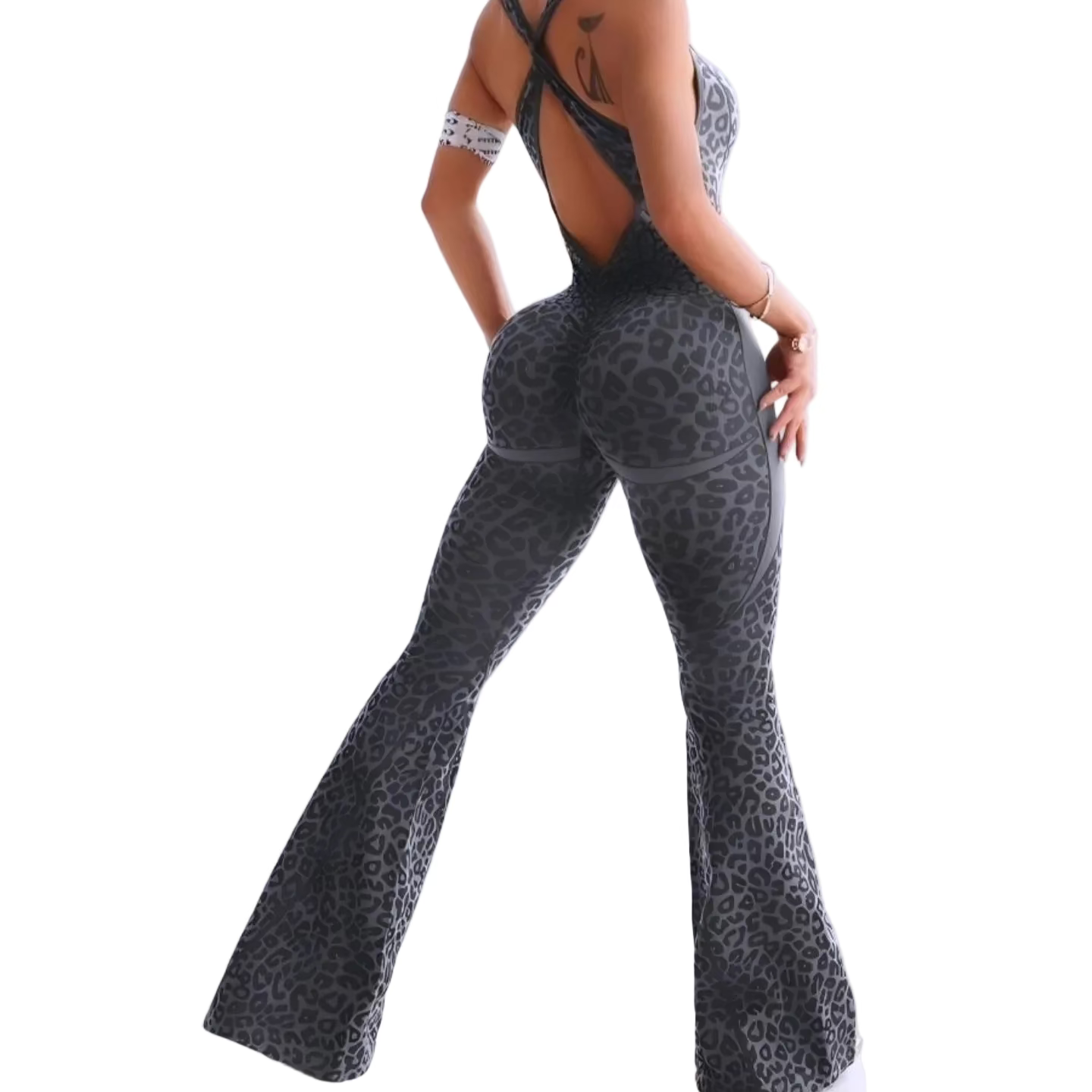 Person wearing a leopard print outfit with flared pants on a white background