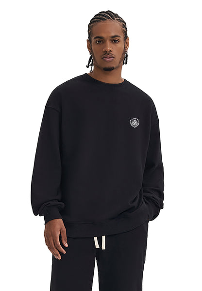 Person wearing a black sweatshirt with a logo on a white background