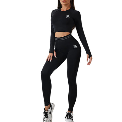 Person wearing a black athletic outfit with a logo on a plain background