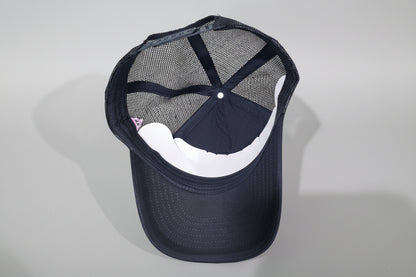 Black cap with mesh back on a wooden surface
