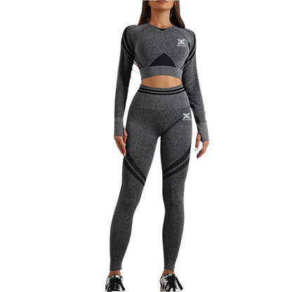 Person wearing a gray athletic outfit with black accents on a plain background