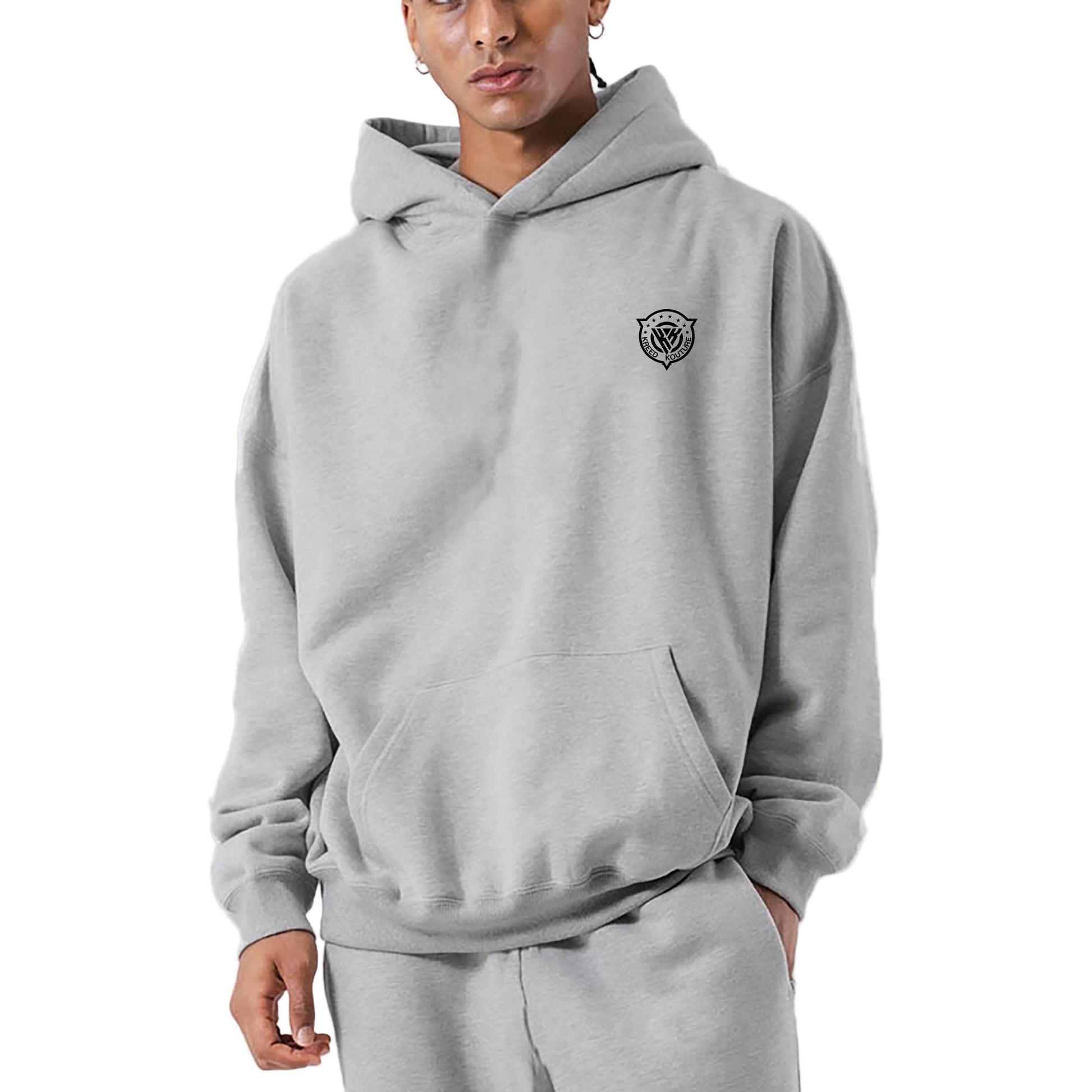 Person wearing a gray hoodie with a logo on a light gray background