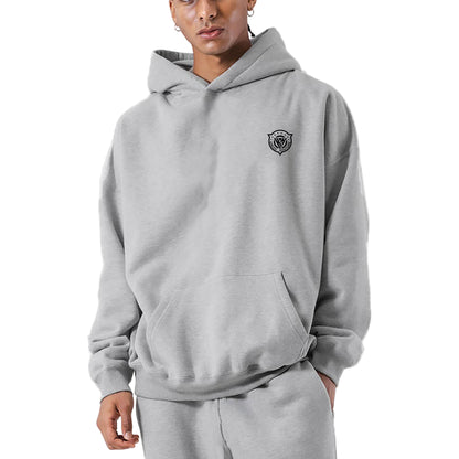 Person wearing a gray hoodie with a logo on a light gray background