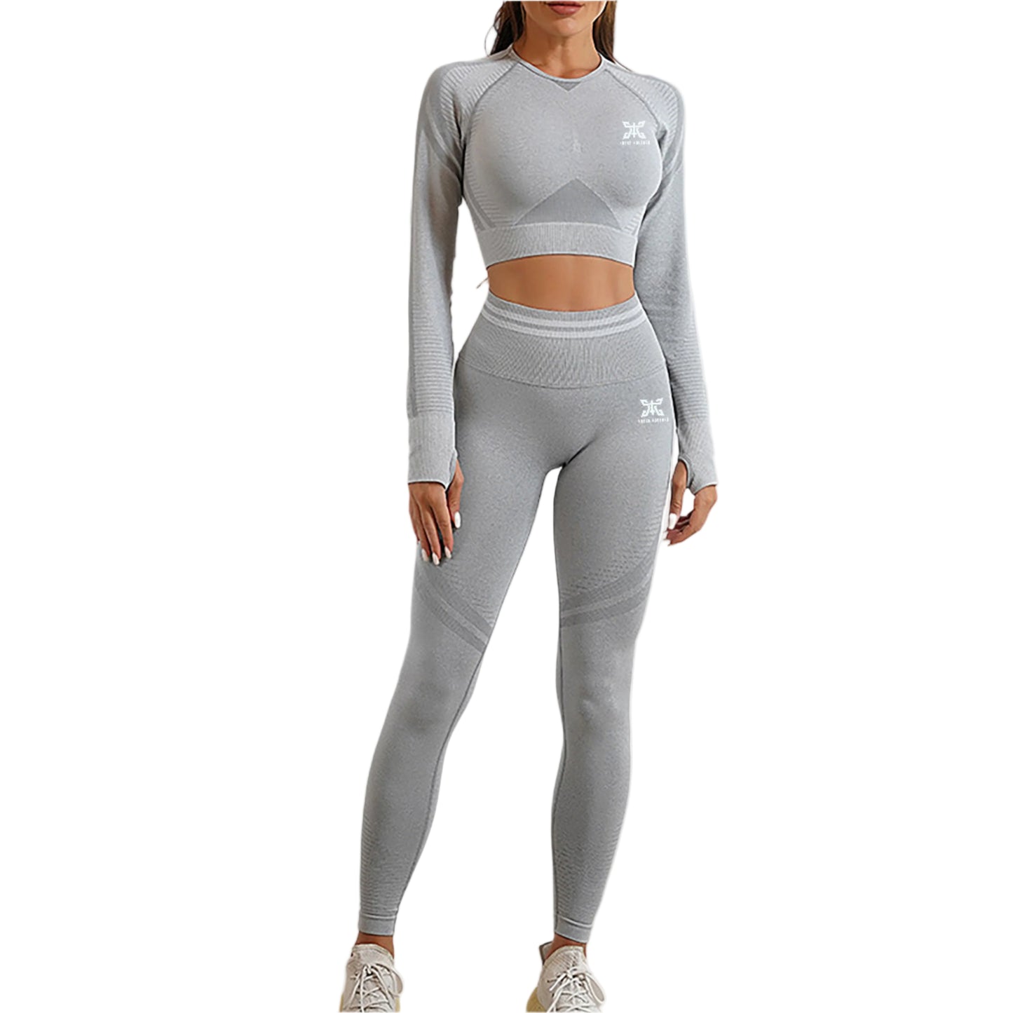 Person wearing a gray athletic outfit with a logo on a plain background