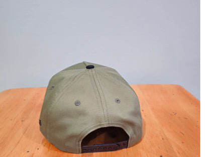 Green cap on a wooden surface with a gray background