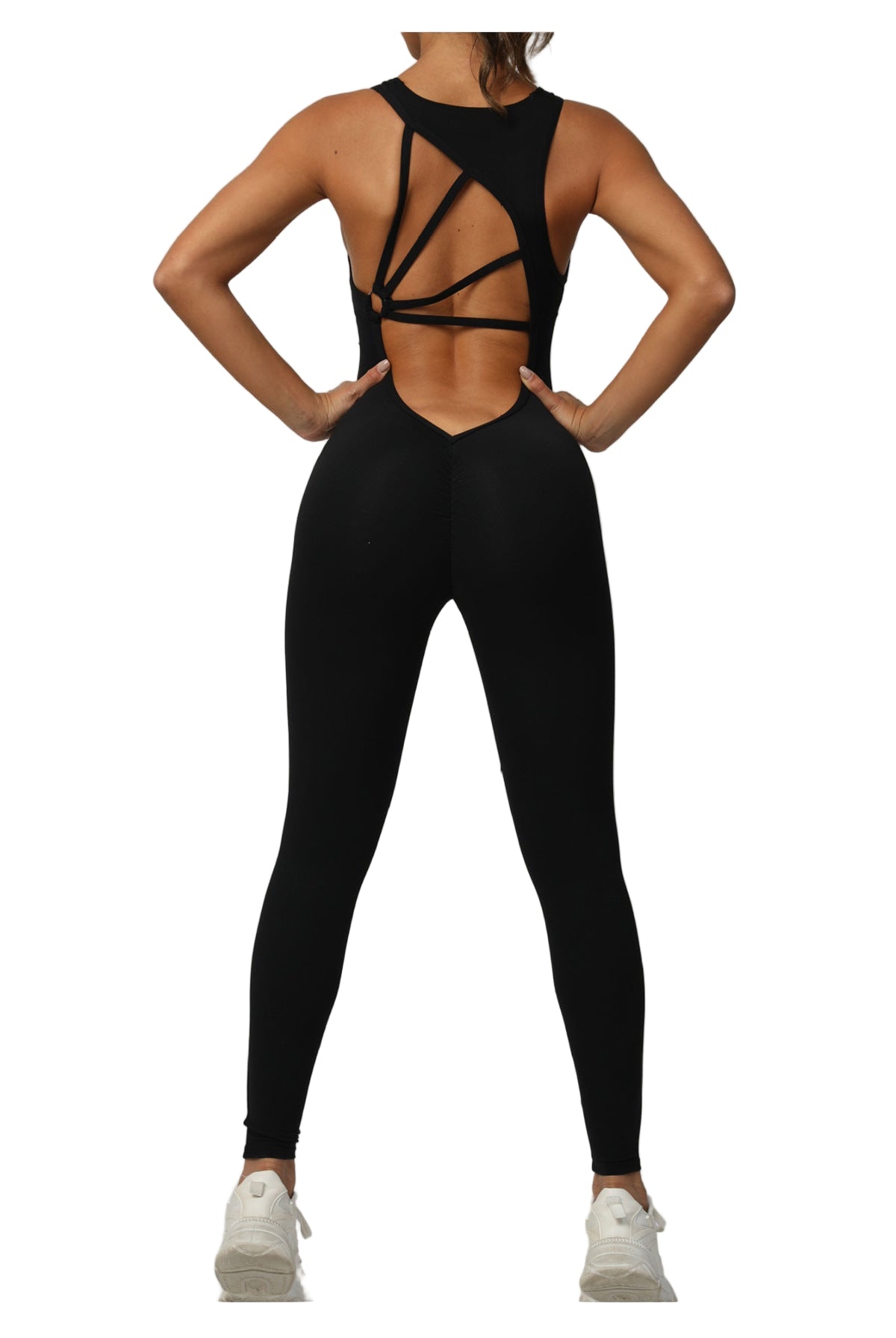 Person wearing a black strappy top and leggings on a light gray background