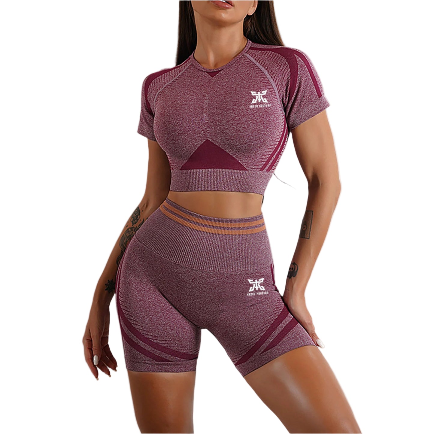 Woman wearing a maroon athletic outfit with a logo on a neutral background
