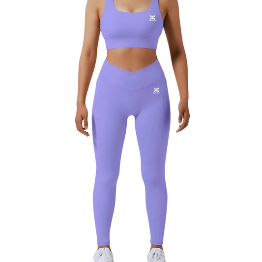 Person wearing a purple athletic outfit with a logo on a light gray background