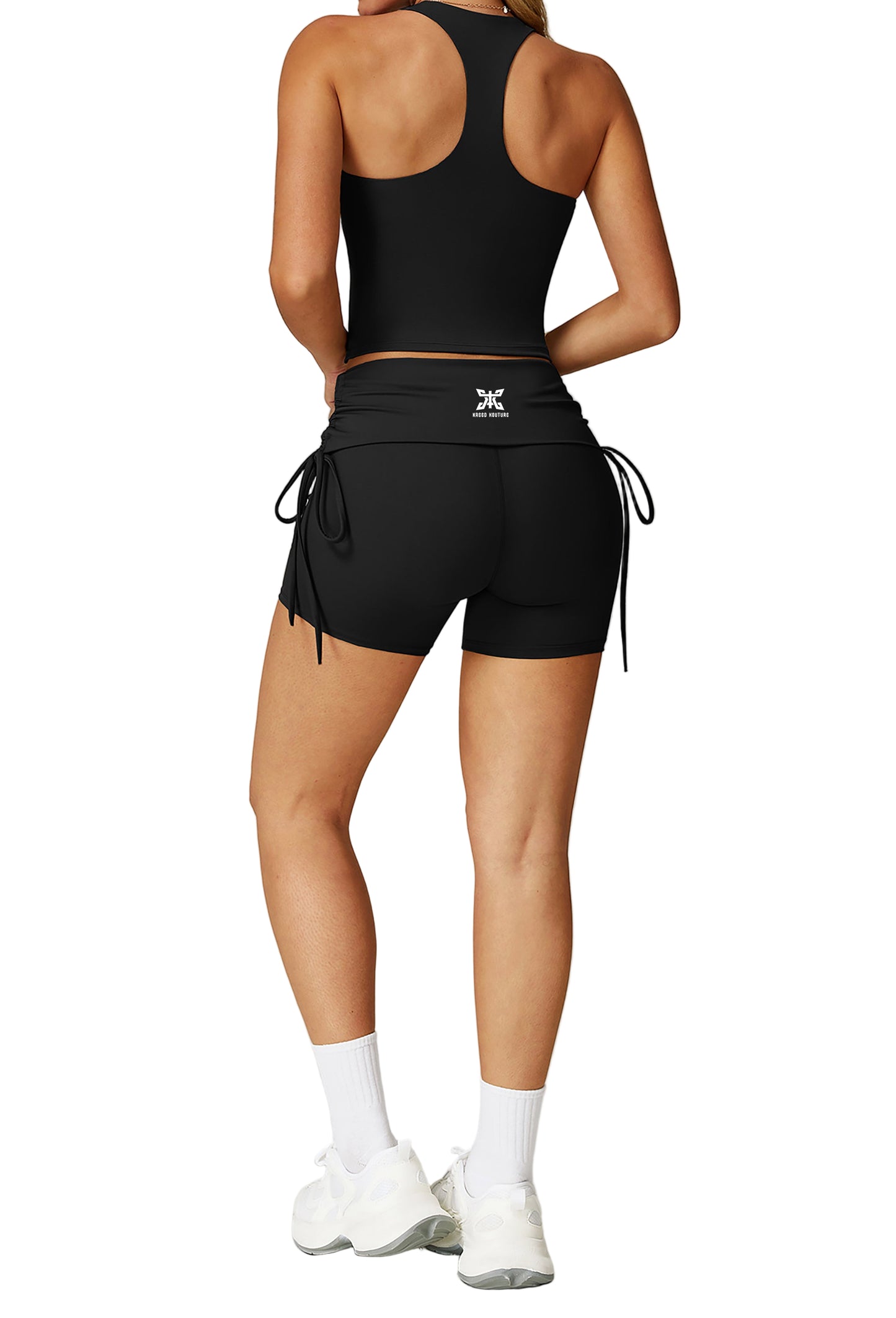 Person wearing a black athletic outfit with drawstrings on a light gray background