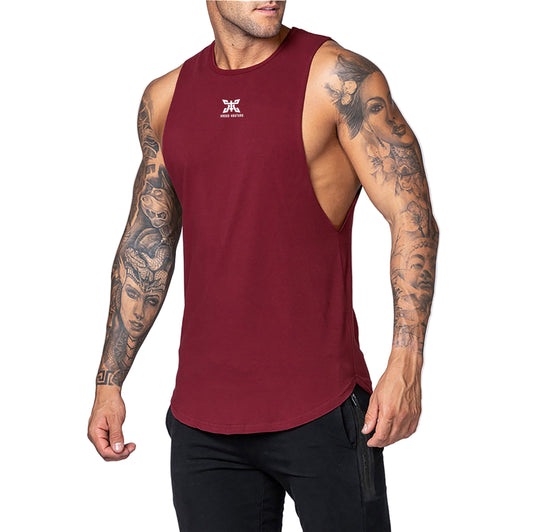 Man wearing a maroon tank top with a logo on a light gray background