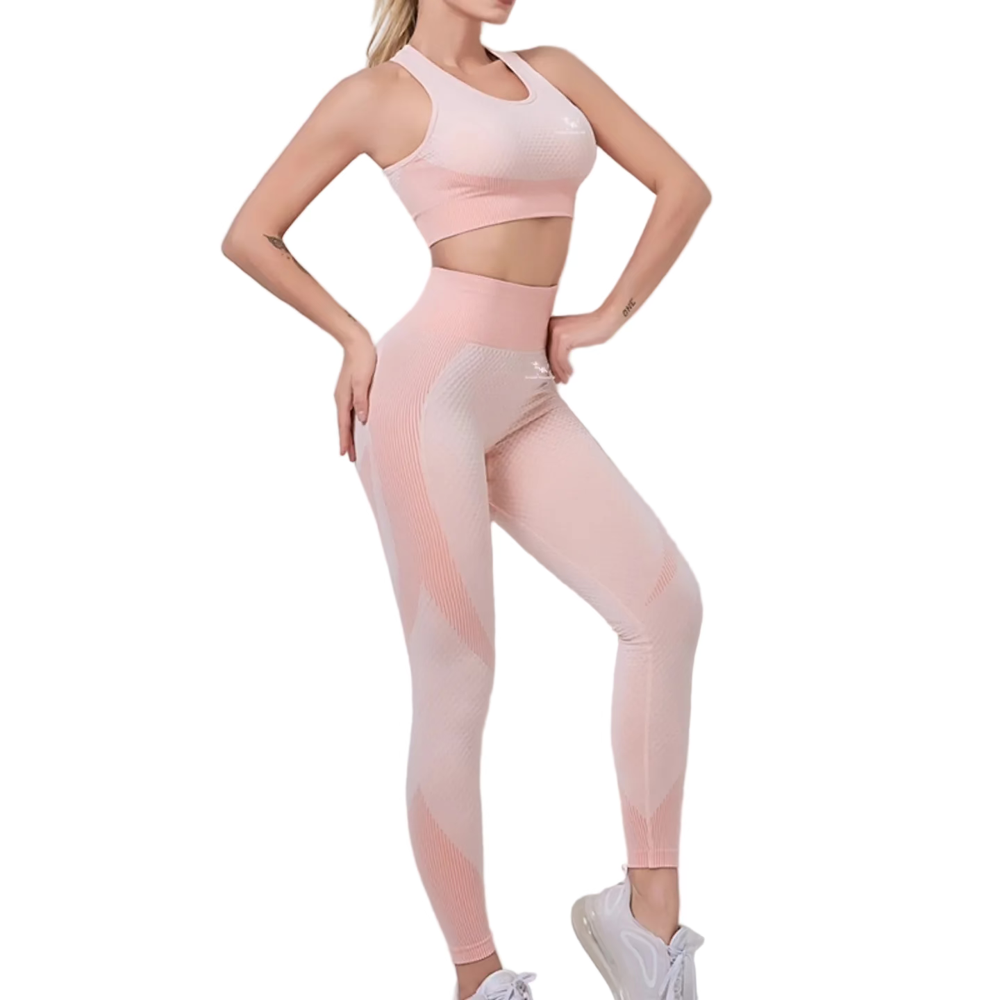 Woman wearing a pink athletic outfit on a light gray background