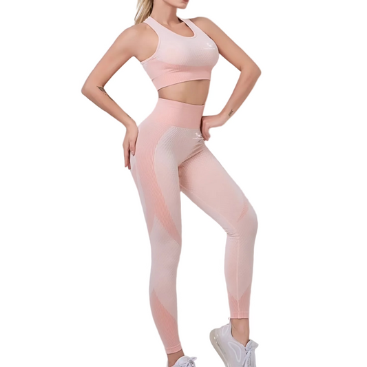 Woman wearing a pink athletic outfit on a light gray background
