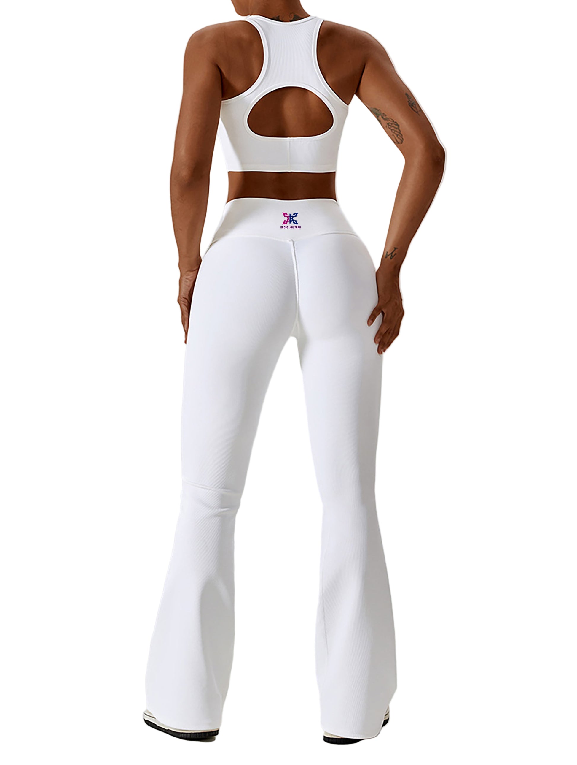 Person wearing a white sports bra and leggings with a logo on a light gray background