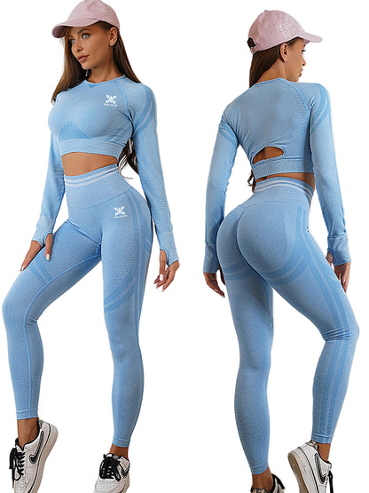 Woman wearing a blue athletic outfit with cut-out design on a plain background