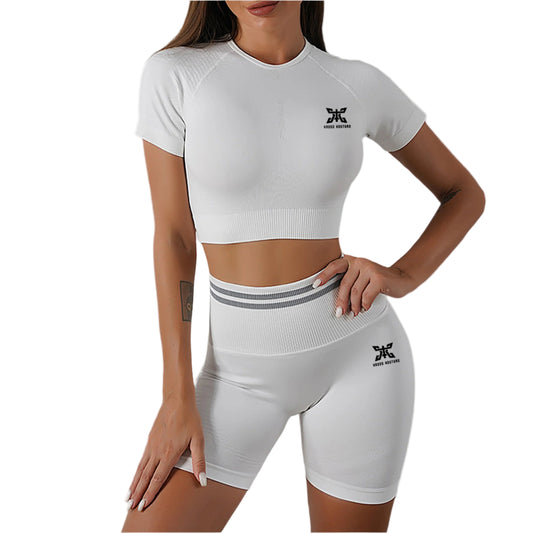 Person wearing a white athletic outfit with a logo on a gray background